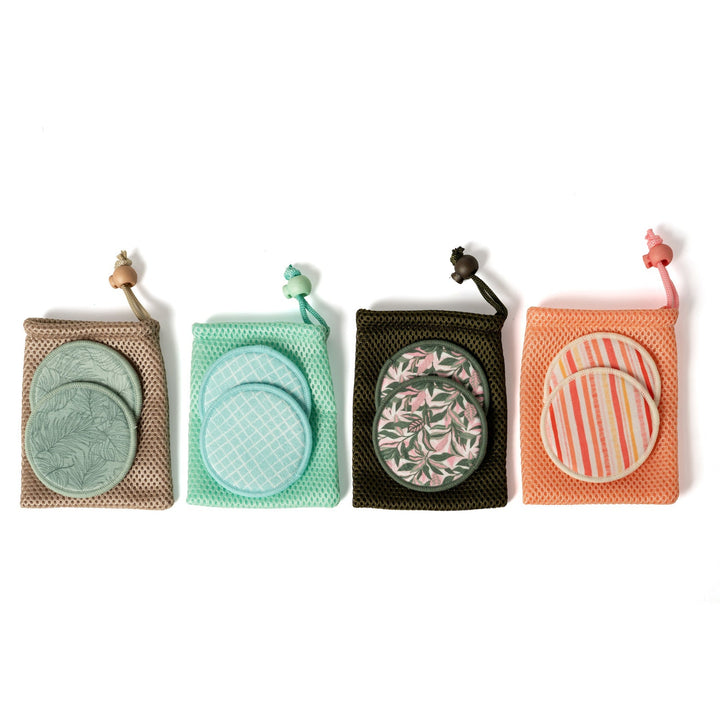 Four reusable cotton pads in different designs and colors on a white background