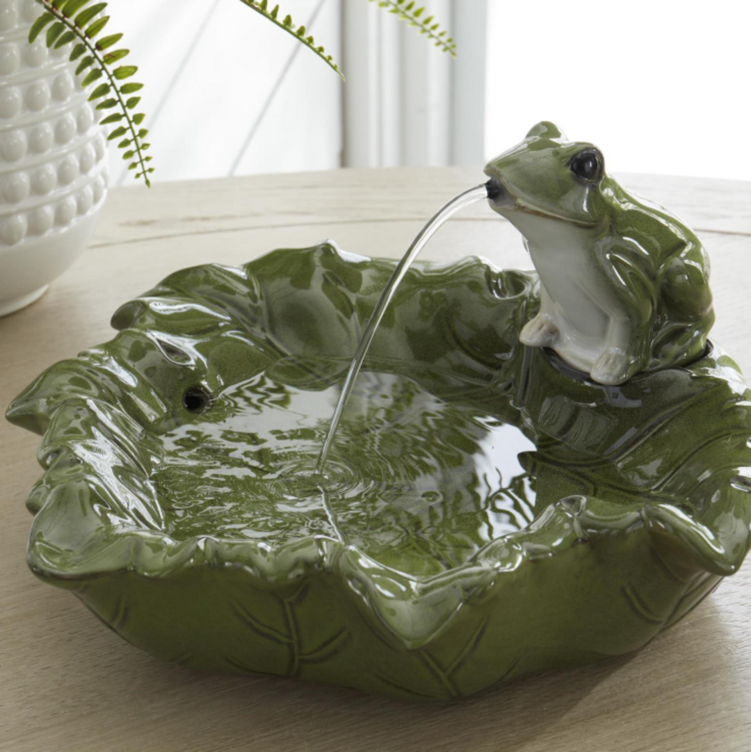 Frog-themed water fountain on a leaf-shaped base