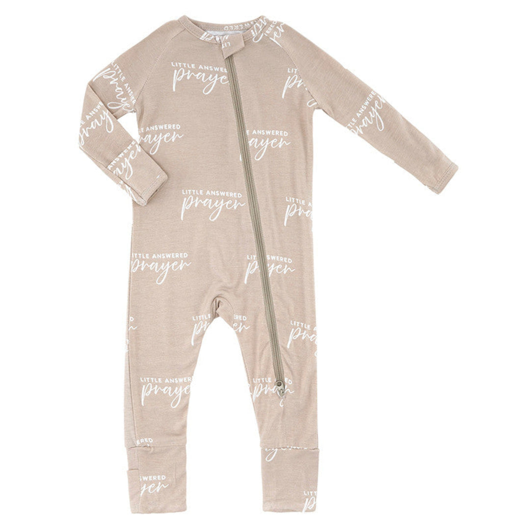 Beige baby onesie with white text on a white background