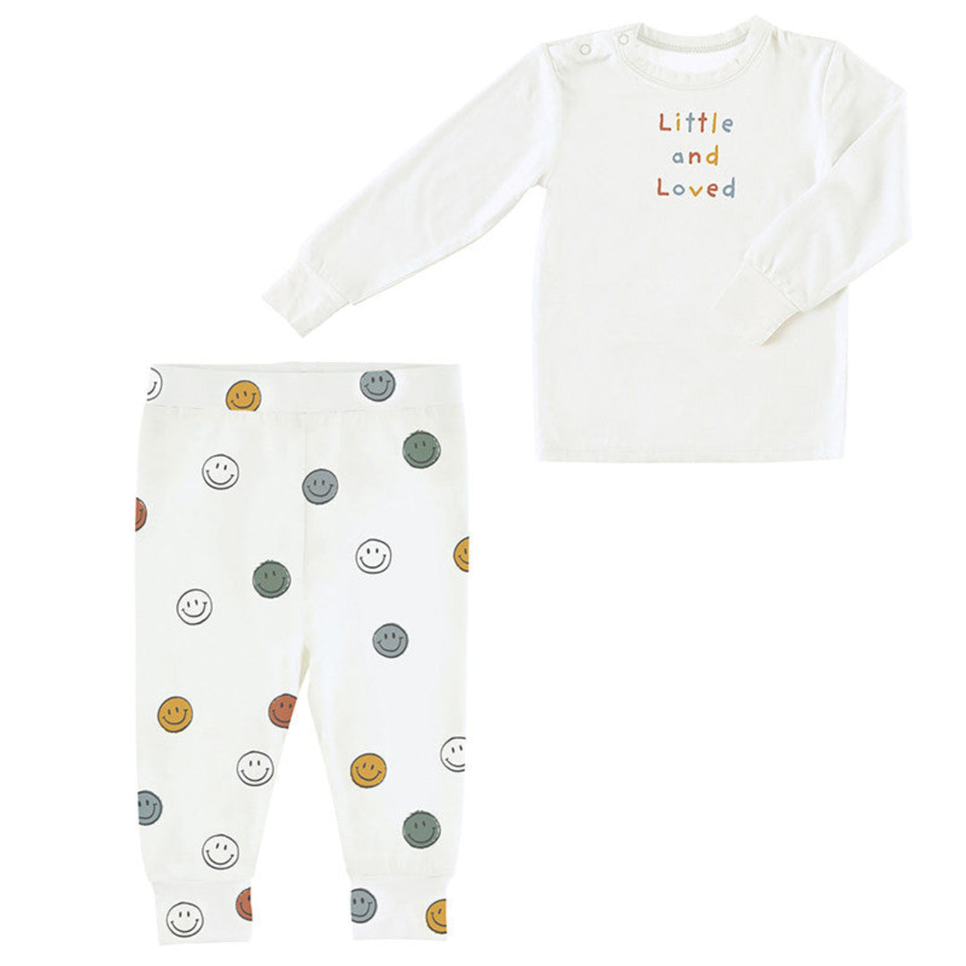 Baby outfit with long-sleeve top and pants featuring smiley face patterns on a white background