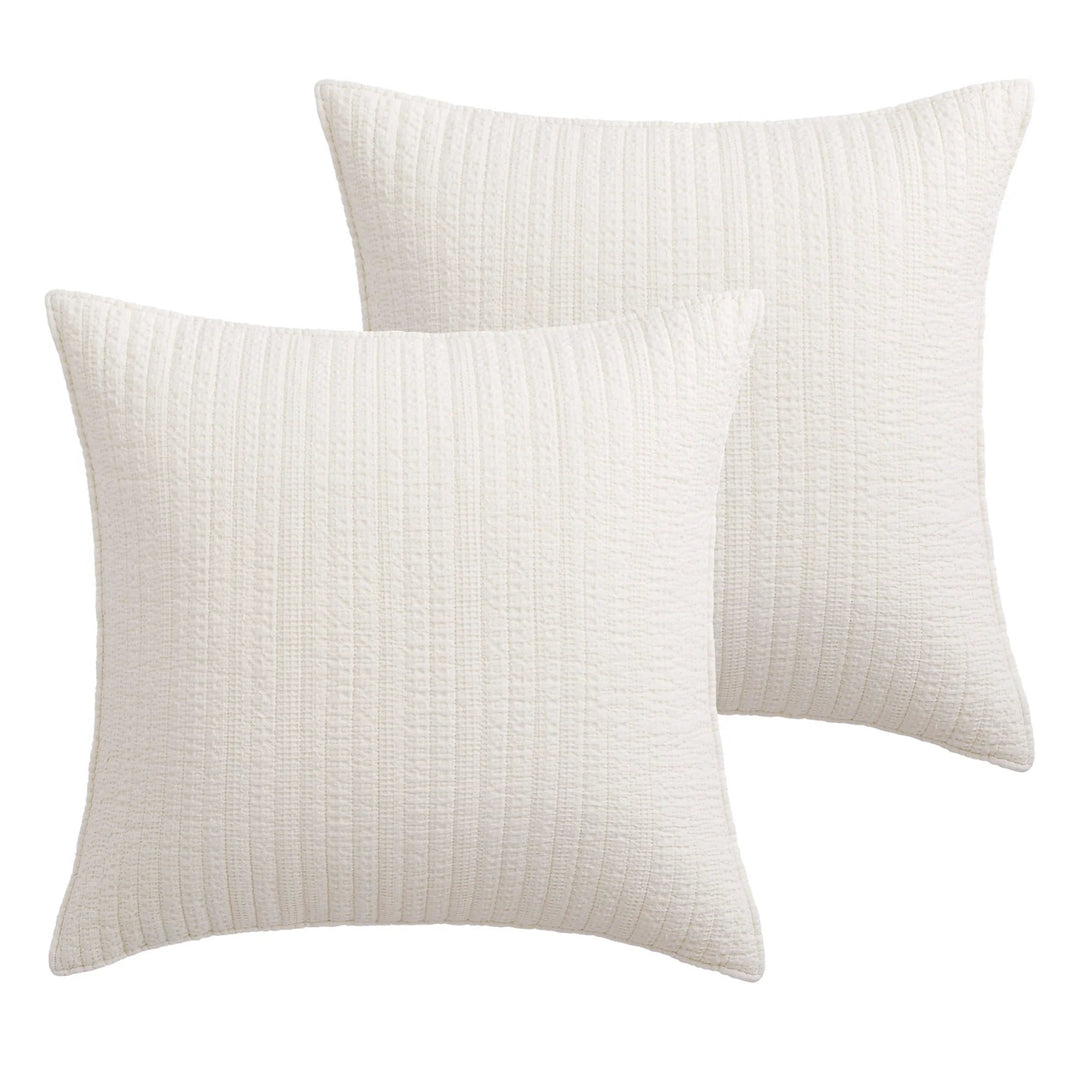 Two textured pillows on a white background