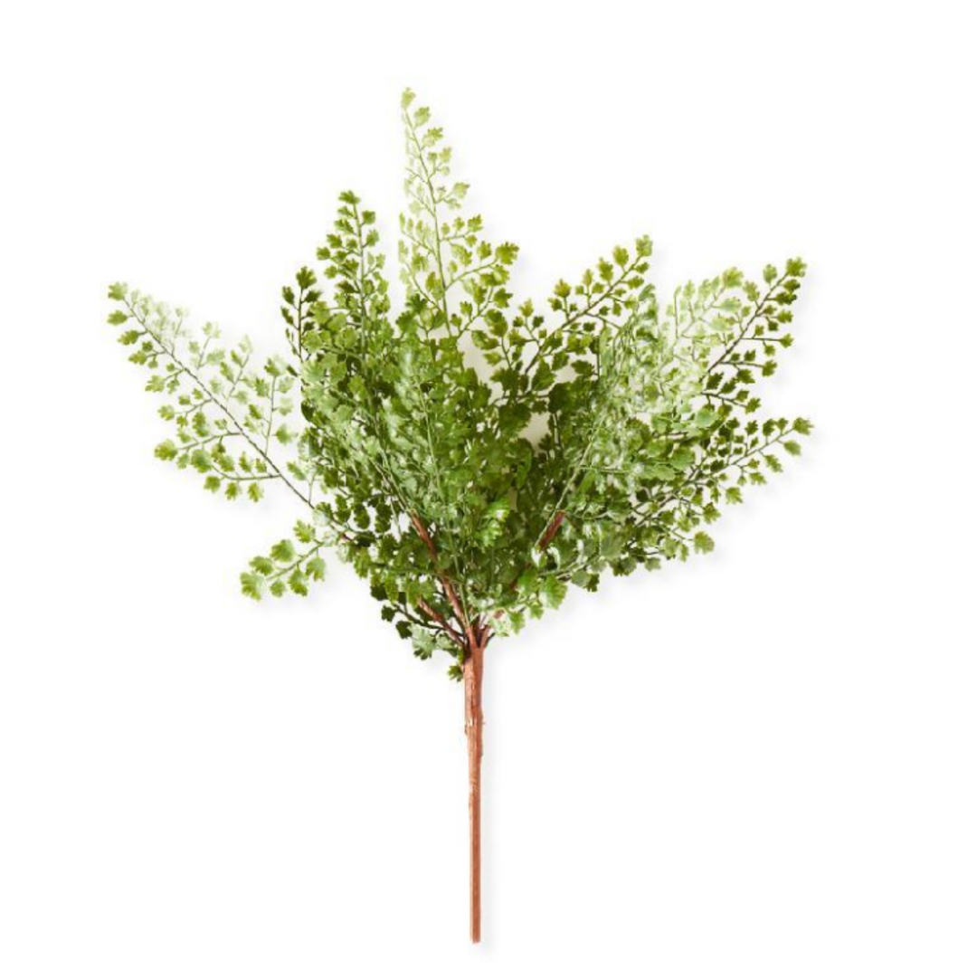 Artificial green leafy branch on a white background