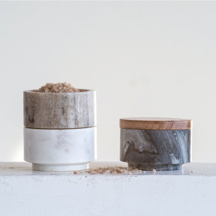 Three ceramic pots with natural patterns on a white surface