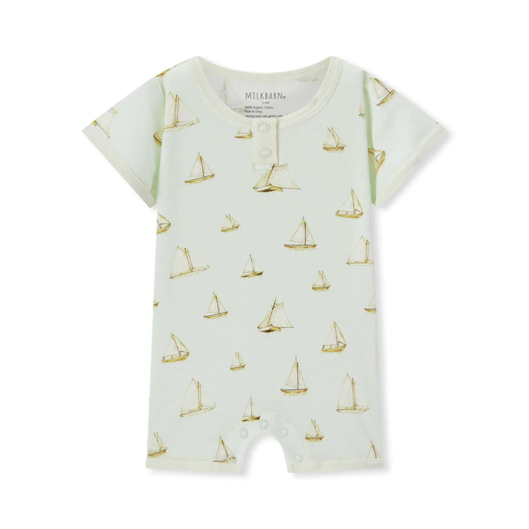 Baby romper with sailboat pattern on a white background