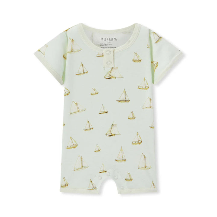 Baby romper with sailboat pattern on a white background