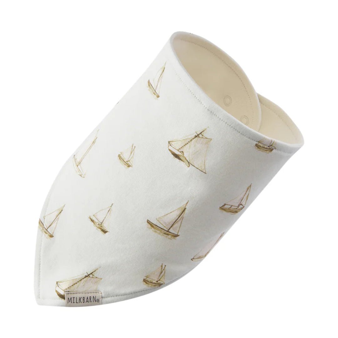 Baby bib with sailboat pattern on a white background