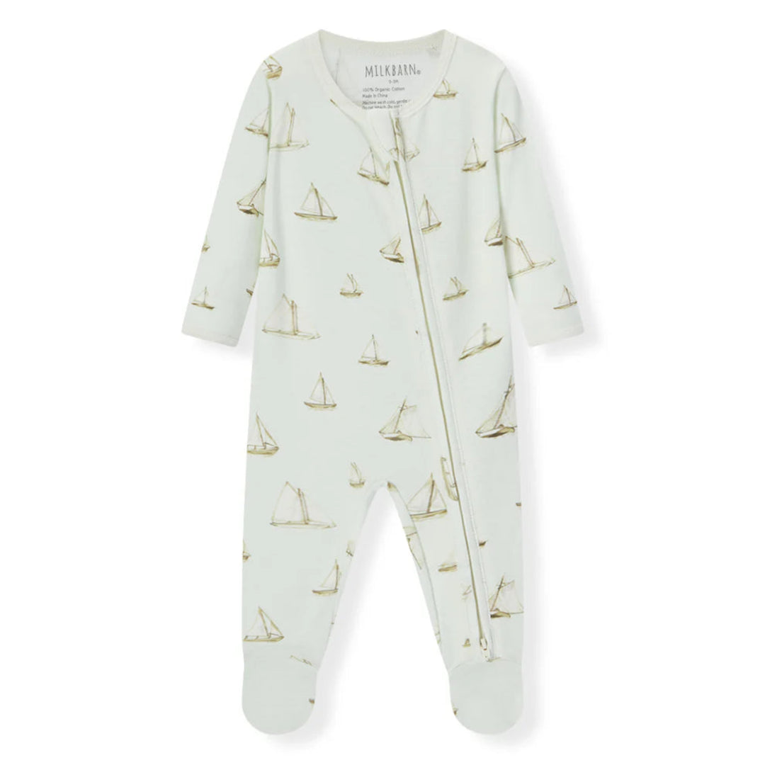 Baby onesie with sailboat pattern on a white background