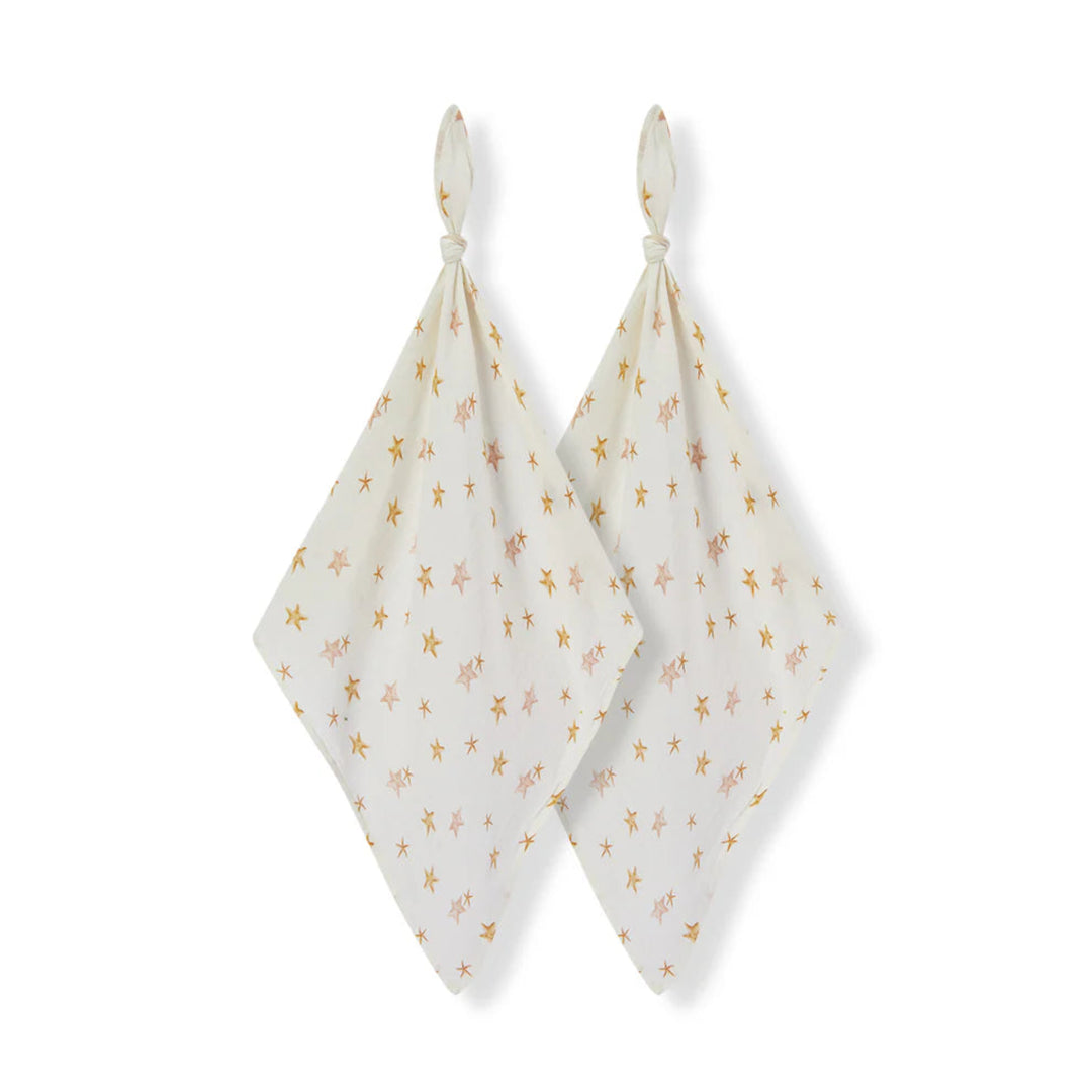 Two white baby swaddle blankets with gold floral patterns on a white background