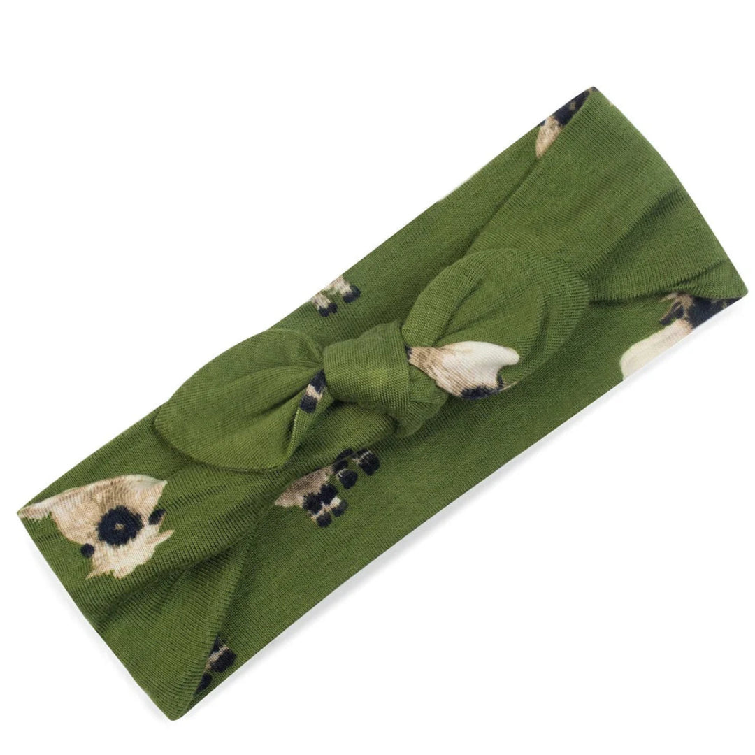 Green headband with a knot and small animal prints on a white background
