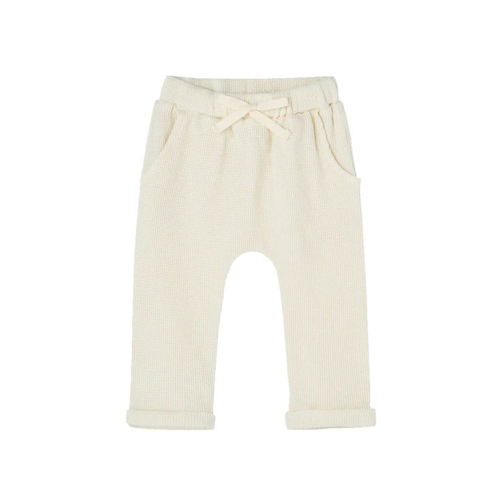White ribbed baby pants with a tie waist on a white background