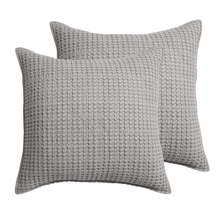 Two gray textured pillows on a white background