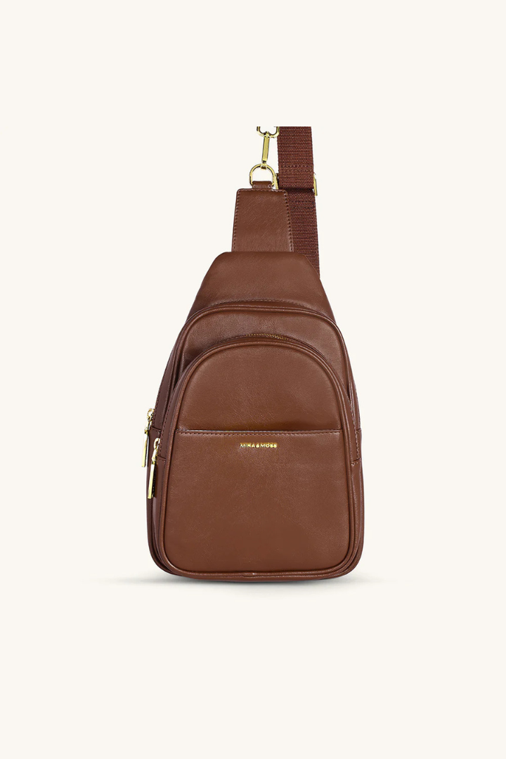 Brown leather sling bag on a white background