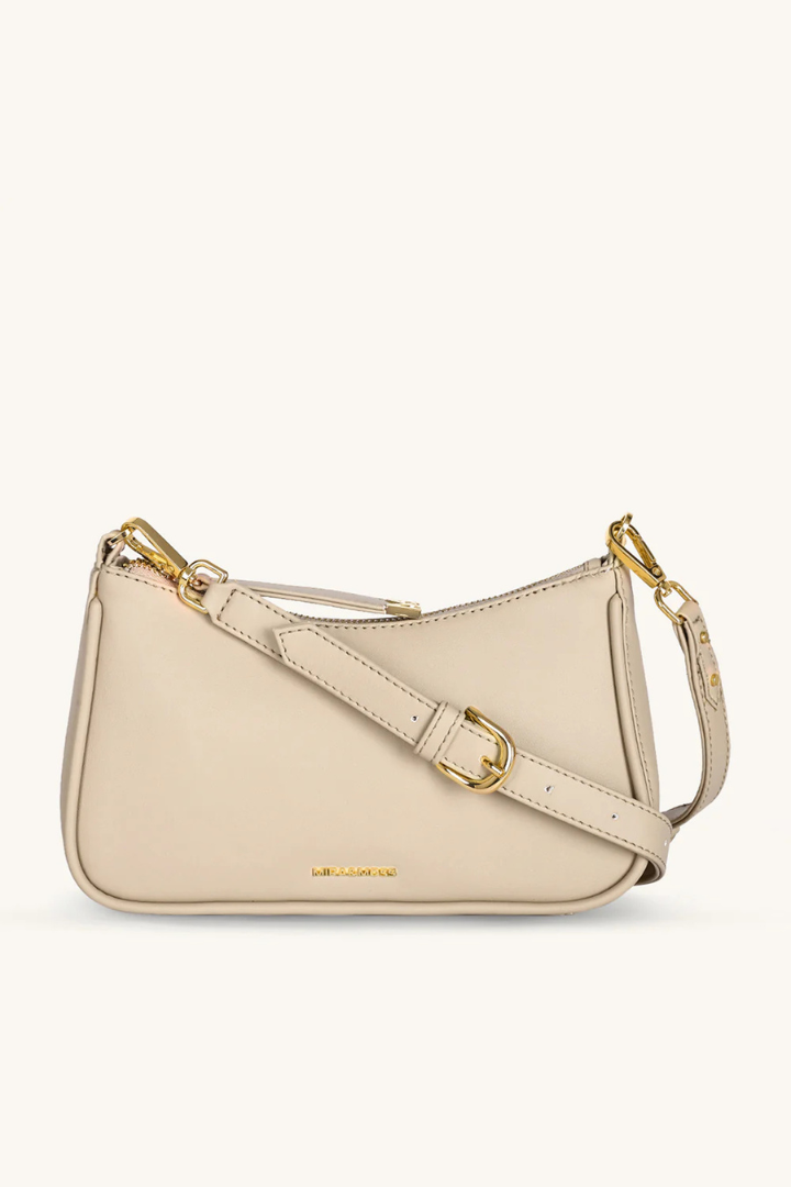Beige handbag with gold accents on a white background