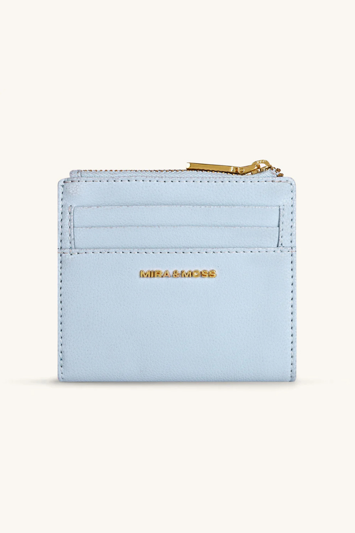 Light blue wallet with gold zipper and 'Mila Louise' branding on a white background