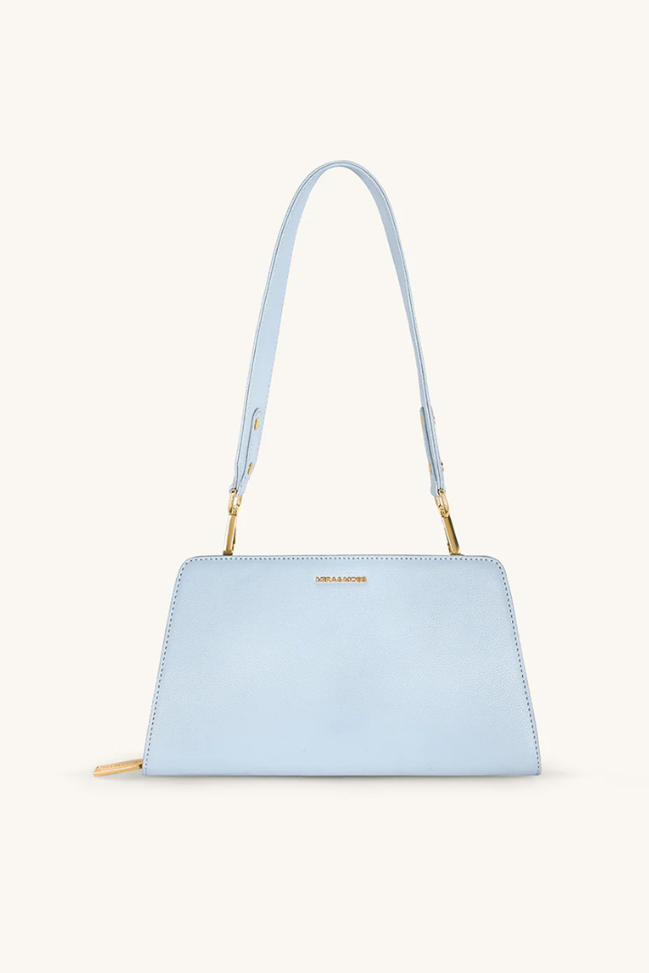 Light blue handbag with a strap on a white background