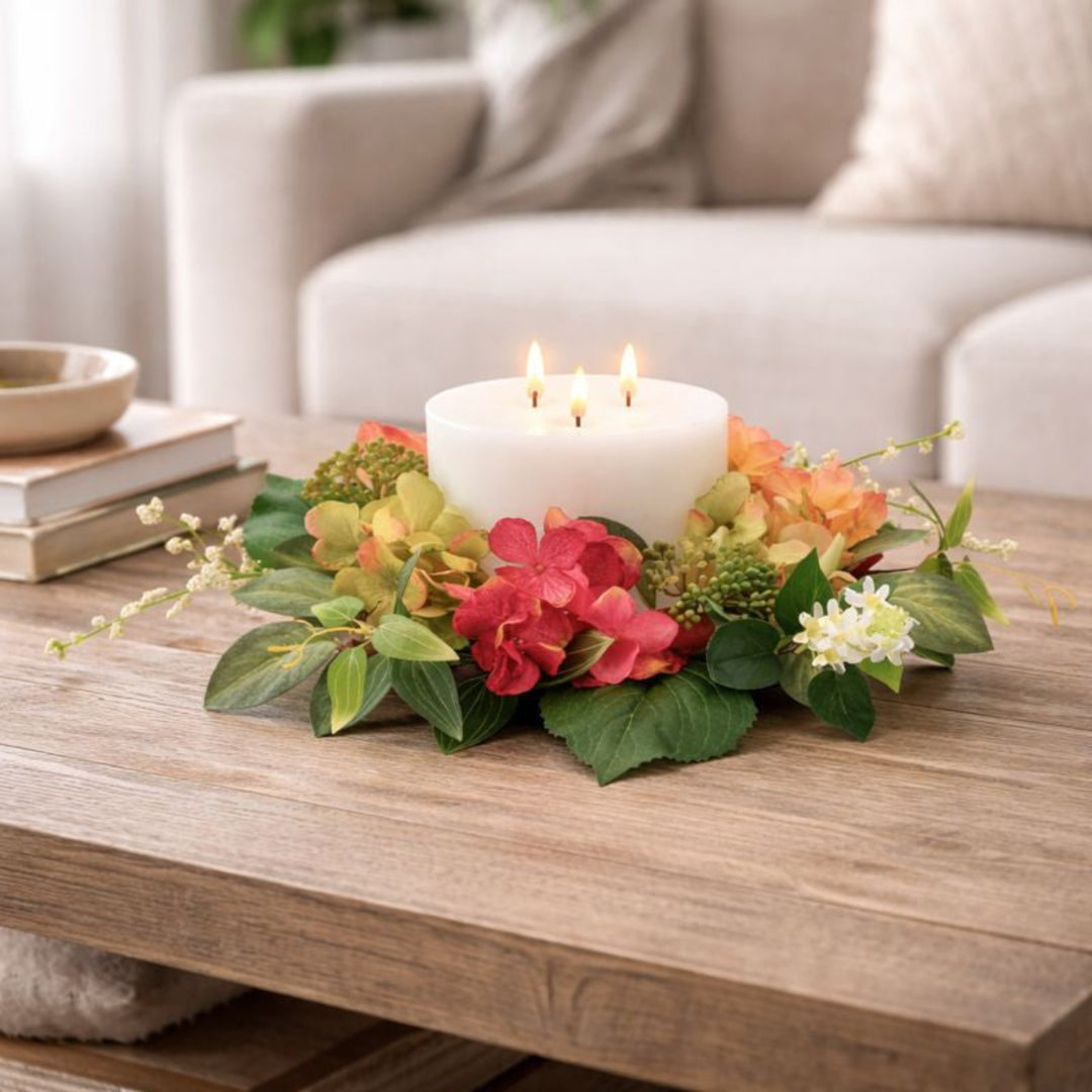Floral arrangement with a candle on a wooden table in a living room setting