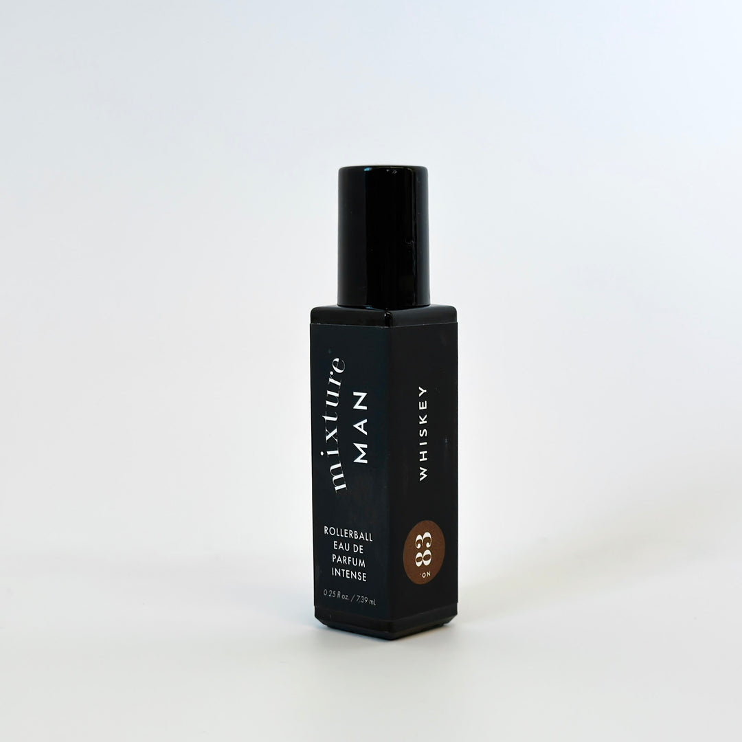 Black bottle of Mixture Man Whiskey perfume on a white background