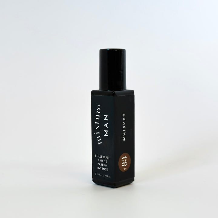 Black bottle of Mixture Man Whiskey perfume on a white background