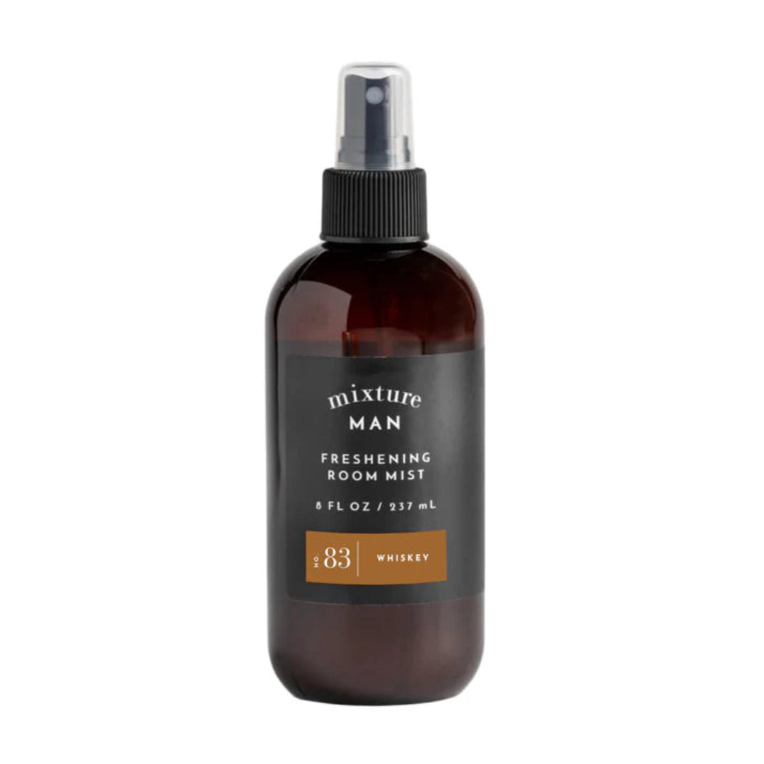 A brown amber bottle with a black spray nozzle, labeled 'MIXTURE MAN FRESHENING ROOM MIST NO. 83 WHISKEY', indicating an 8 oz size.
