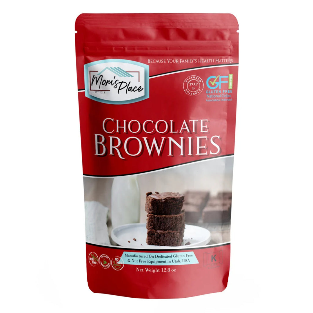 A red stand-up pouch of Mom's Place Chocolate Brownies, featuring a photo of three chocolate brownies on a white plate on the front label, set against a plain white background.