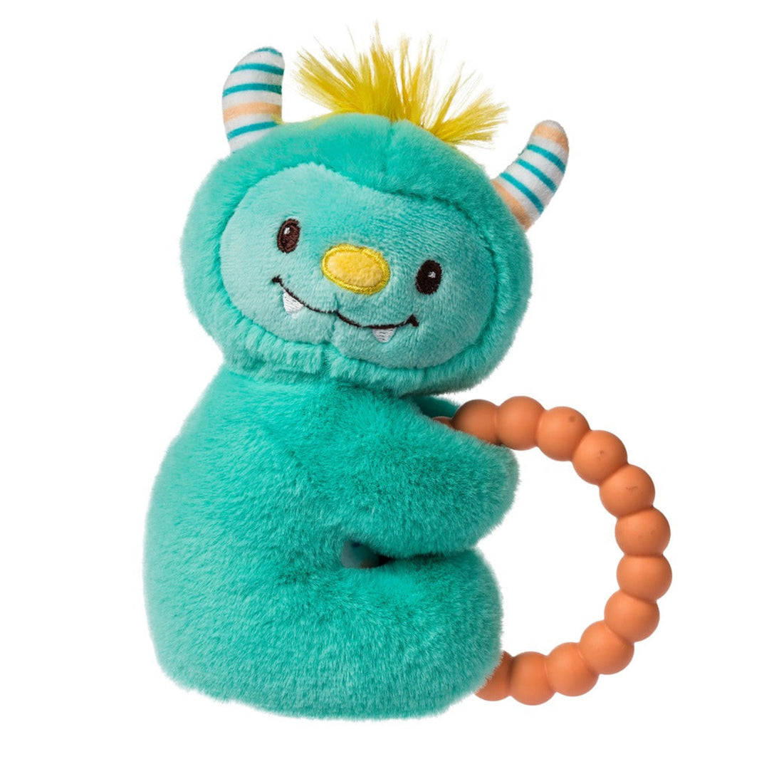 Teal plush toy with horns and a yellow beak holding an orange teething ring on a white background