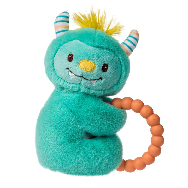 Teal plush toy with horns and a yellow beak holding an orange teething ring on a white background