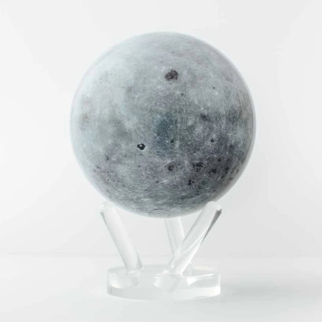 Moon-shaped object on a stand against a white background