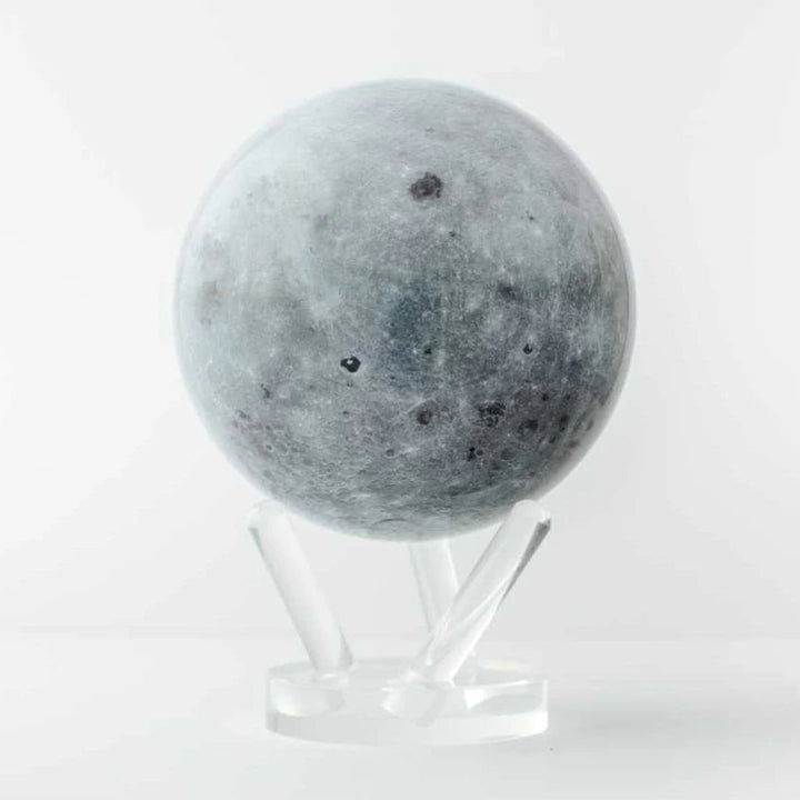 Moon-shaped object on a stand against a white background