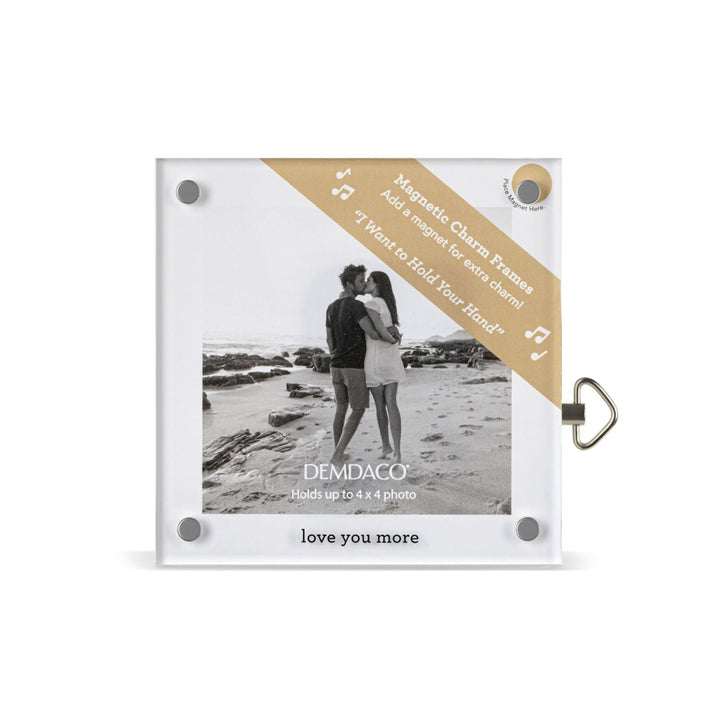 Magnetic charm frame with a photo of a couple on a beach, featuring the Demdaco brand.