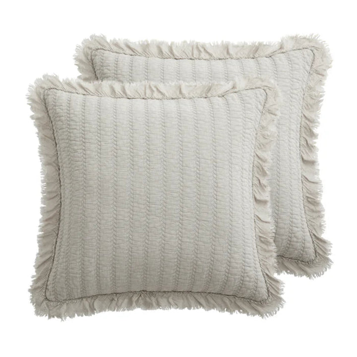 Two gray textured pillows on a white background