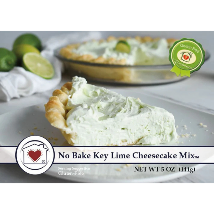 No Bake Key Lime Cheesecake Mix packaging graphic showing a slice of creamy pale green cheesecake in a crust, with limes and a whole pie blurred in the background. Text reads 'No Bake Key Lime Cheesecake Mix' and 'Net Wt 5 OZ (141g)'.