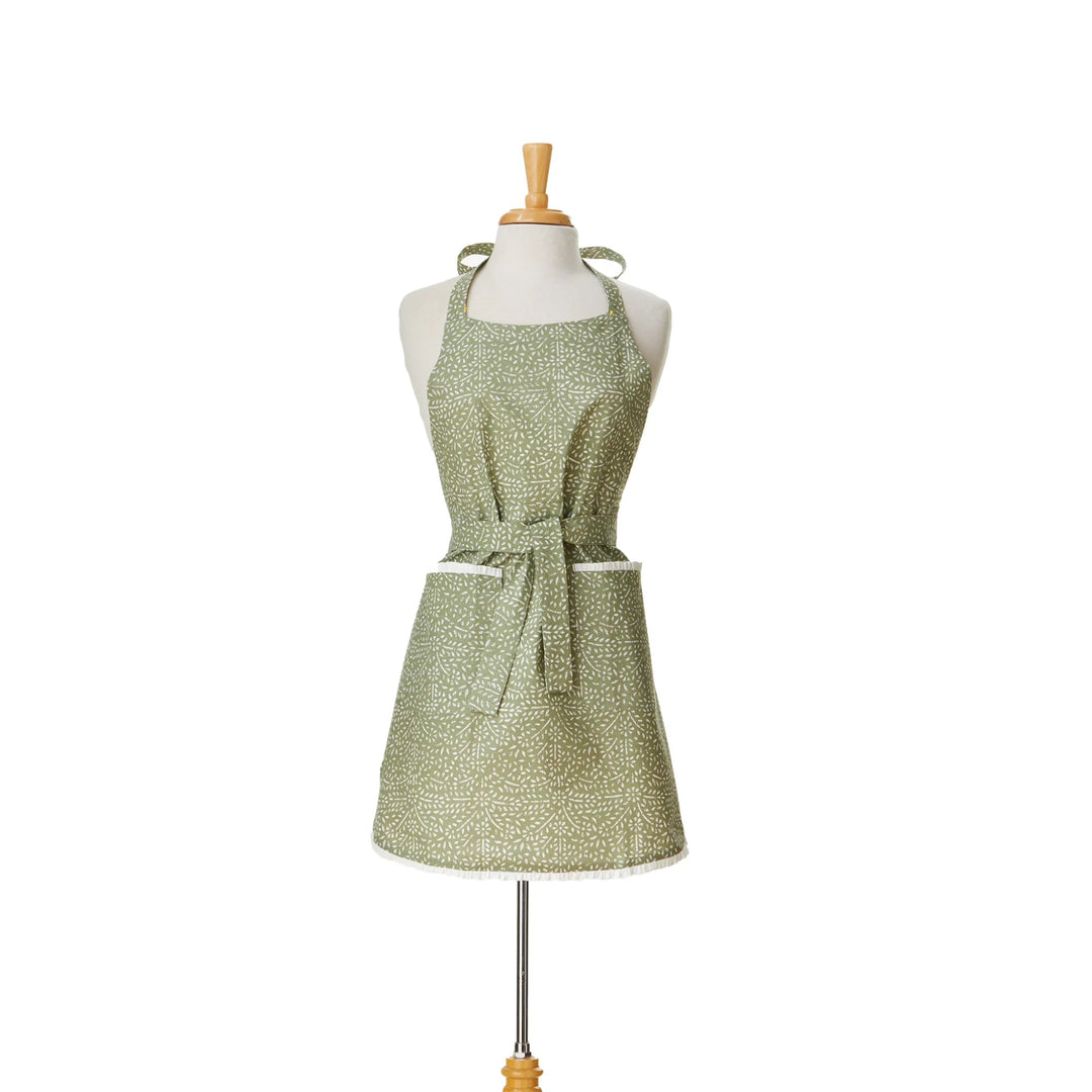 Green patterned apron on a mannequin against a white background