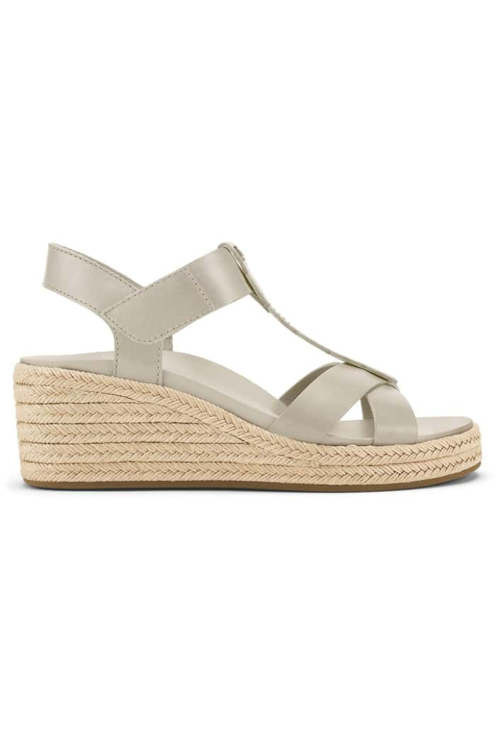 A single women's wedge sandal in a light taupe-beige color, featuring a woven jute platform sole and a slim adjustable ankle strap, shown from a side profile on a white background.