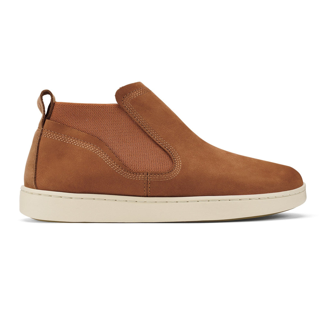 Brown slip-on shoe with a white sole on a white background