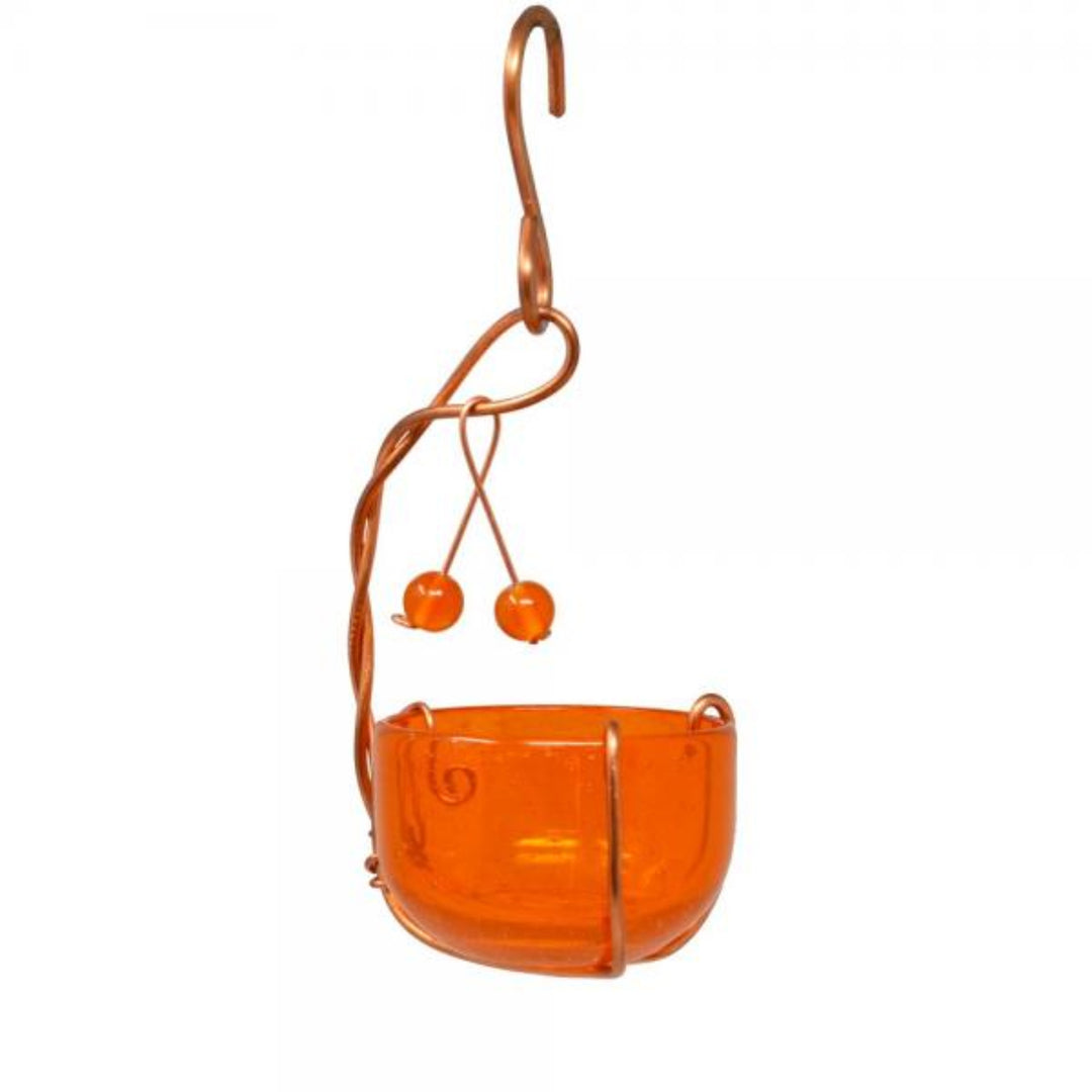 Orange bird feeder with copper hook on a white background