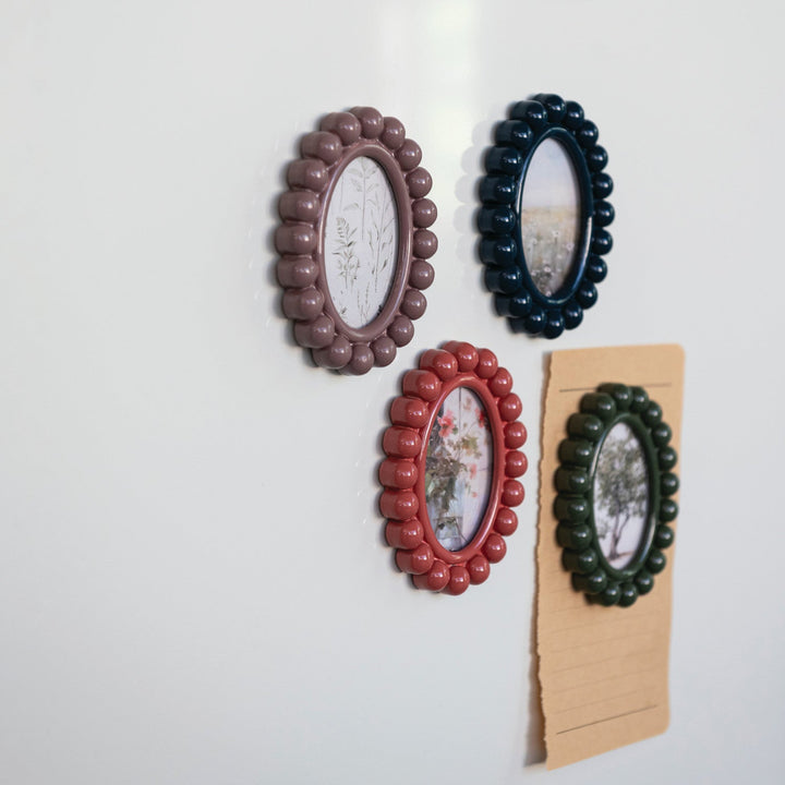 Set of four decorative wall frames in different colors on a white background