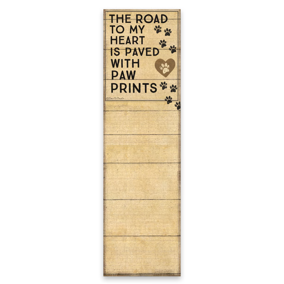 Wooden sign with text 'The road to my heart is paved with paw prints' on a white background