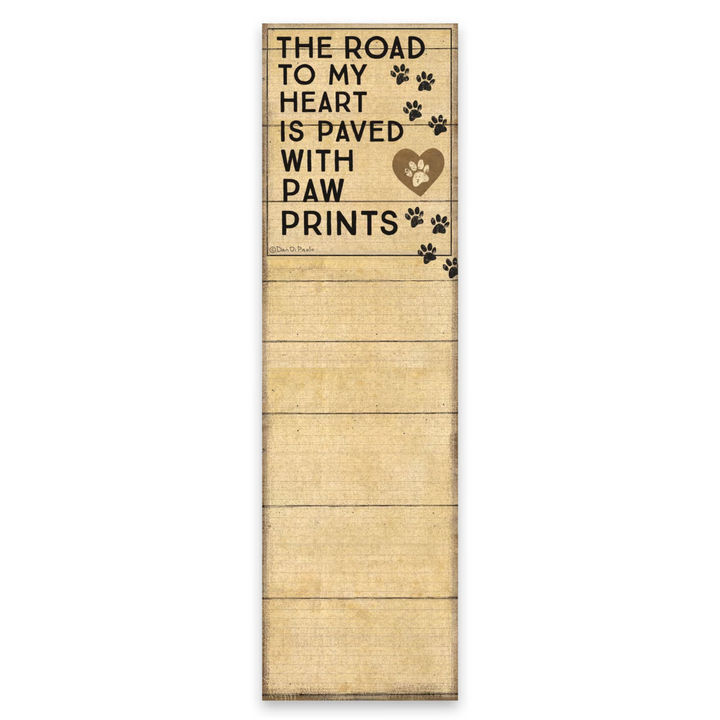Wooden sign with text 'The road to my heart is paved with paw prints' on a white background