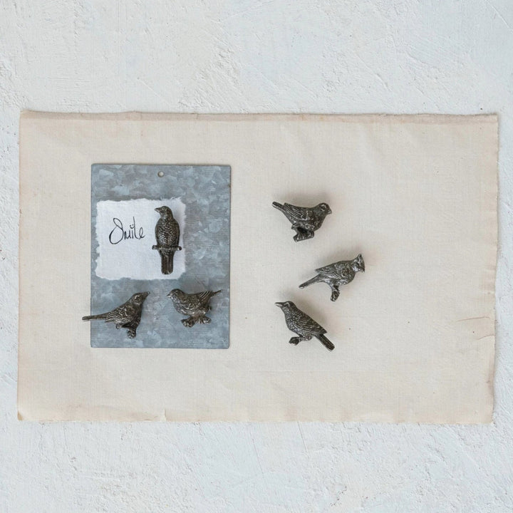 Decorative wall art with bird illustrations on a textured white background