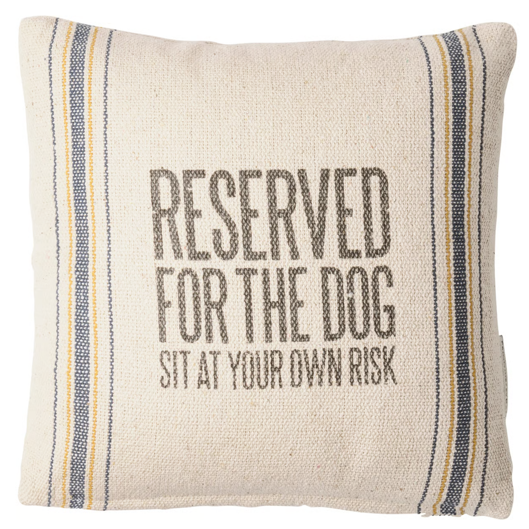 Pillow with text 'Reserved for the dog sit at your own risk' on a striped background