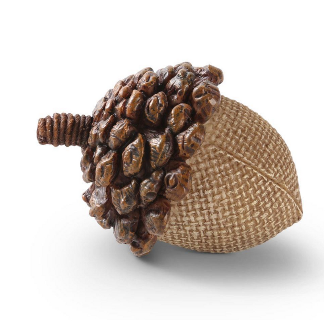 Decorative item resembling an acorn with a textured surface on a white background