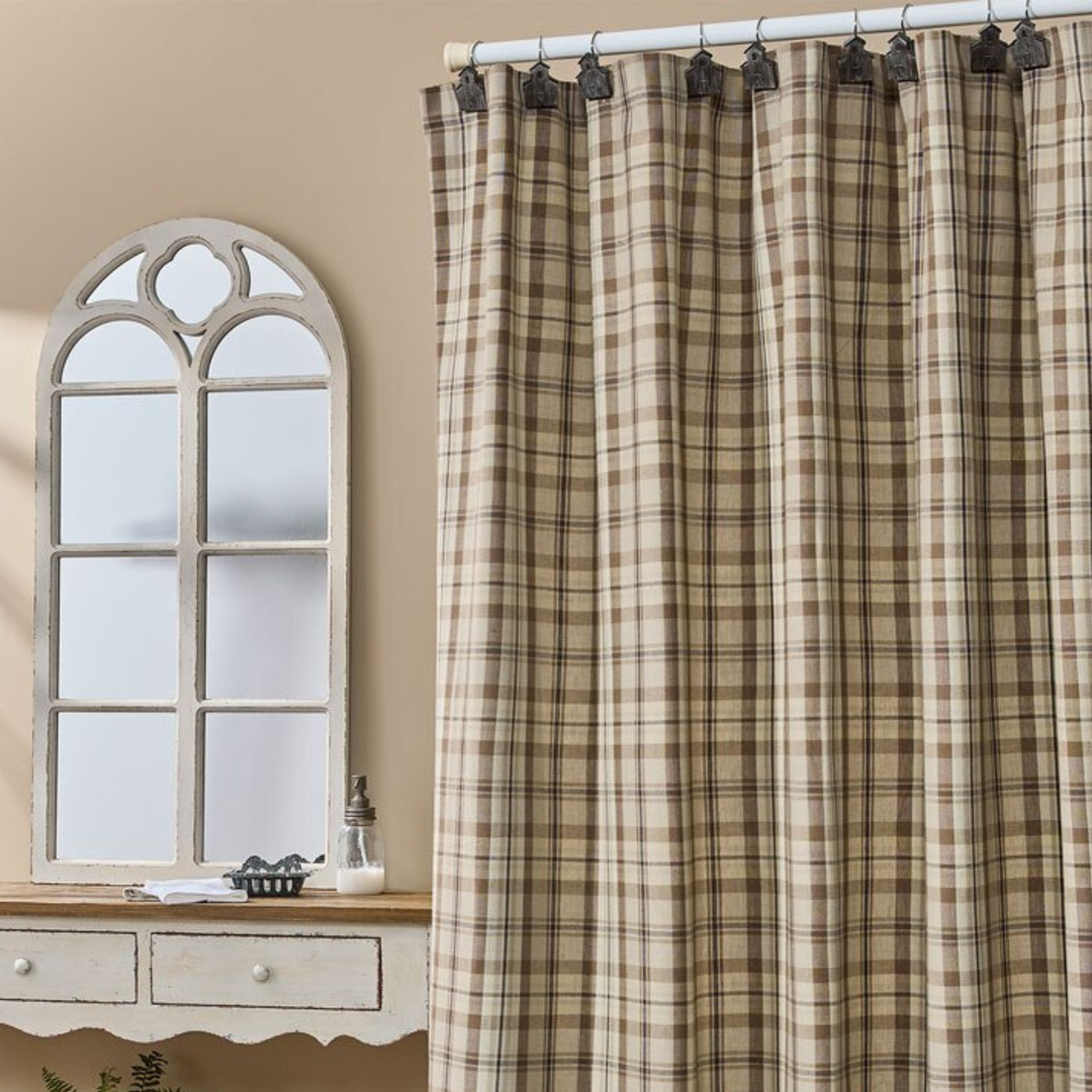Plaid shower curtain in a bathroom with a mirror and window.