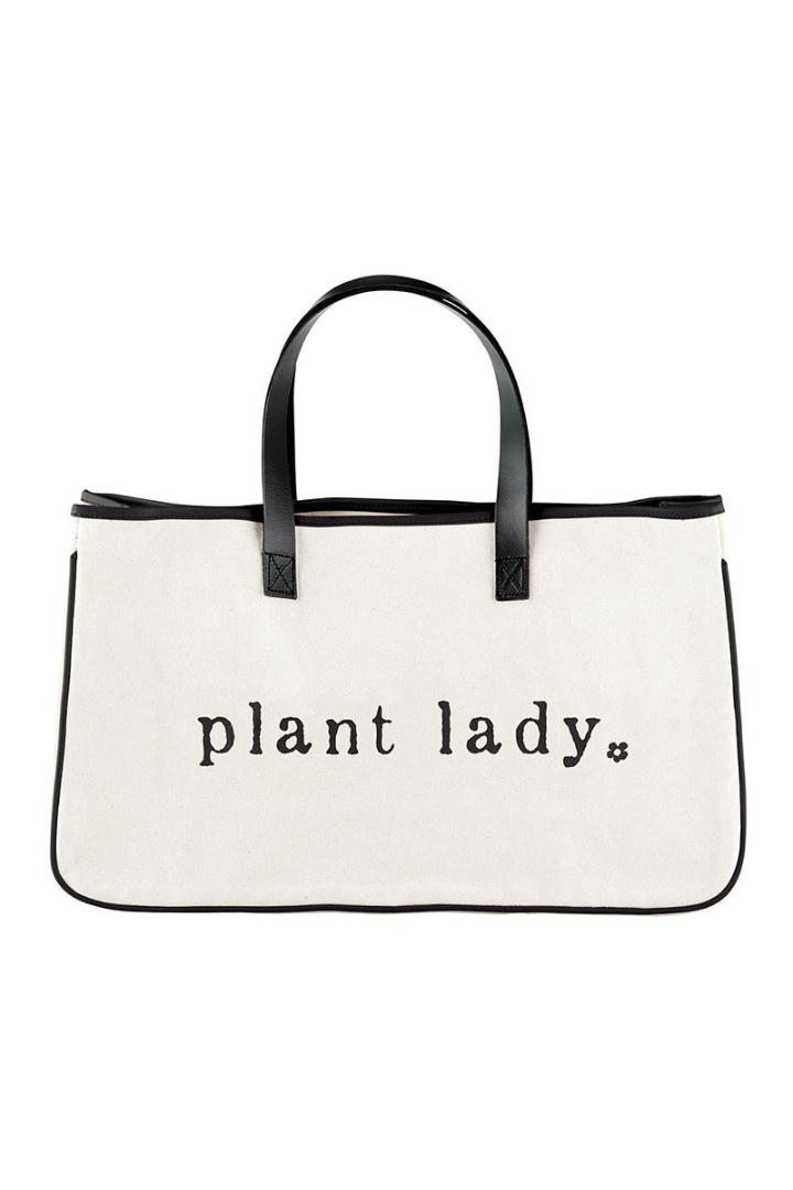 White tote bag with 'plant lady' text and black handles on a white background