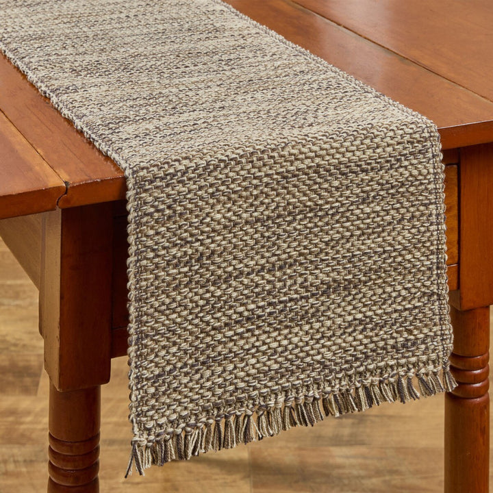 Textured beige table runner on a wooden table
