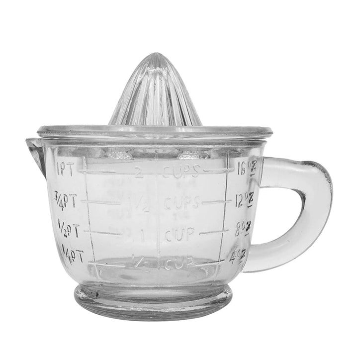 Clear glass juicer with measurement markings on a white background