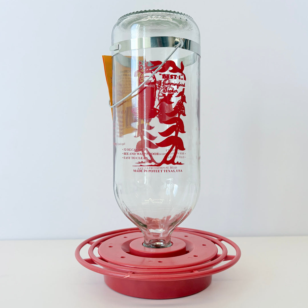 Clear glass container with red design on a white background