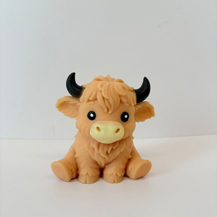 Toy highland cow on a white background