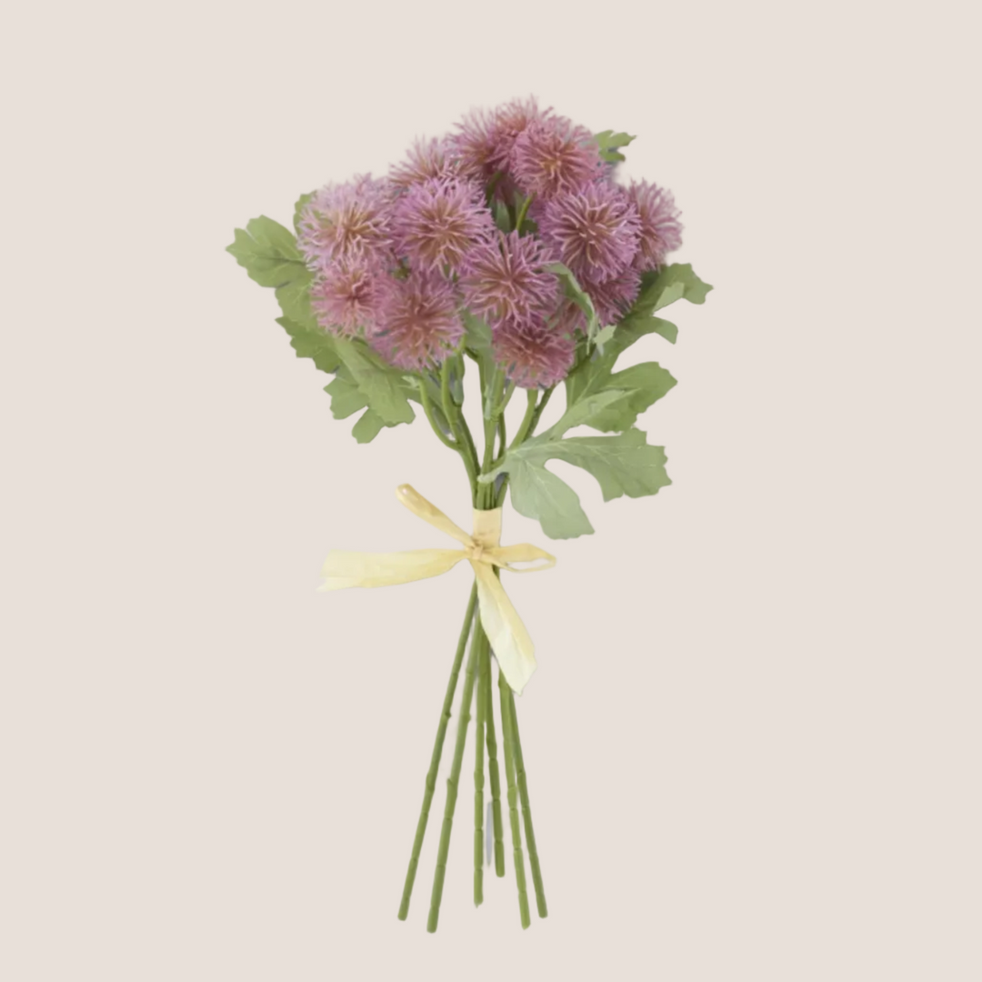 Bouquet of purple flowers with green leaves and a yellow ribbon on a white background