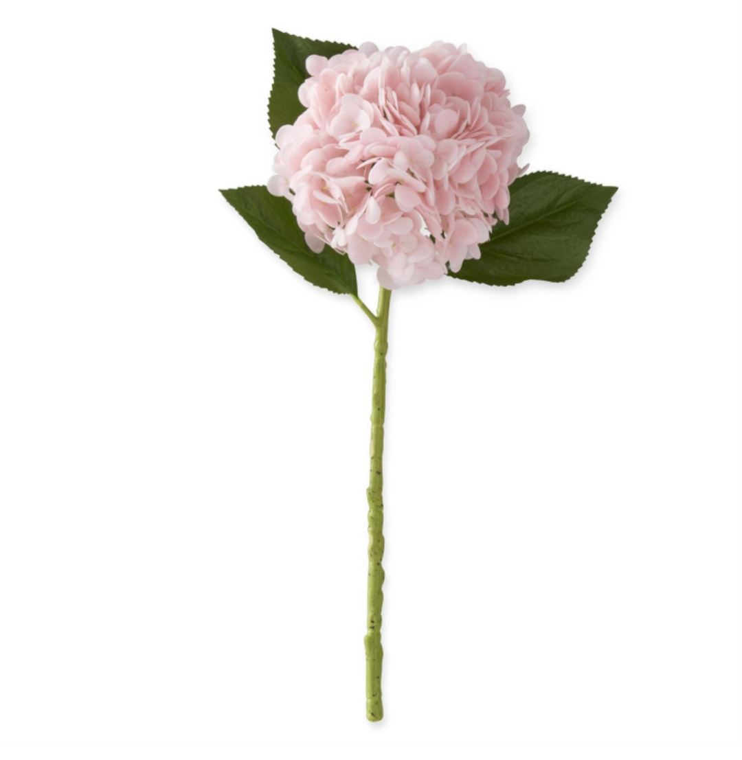 Pink artificial flower with green leaves on a white background