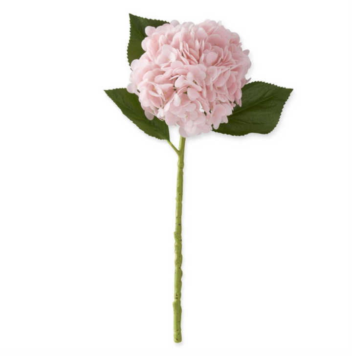 Pink artificial flower with green leaves on a white background